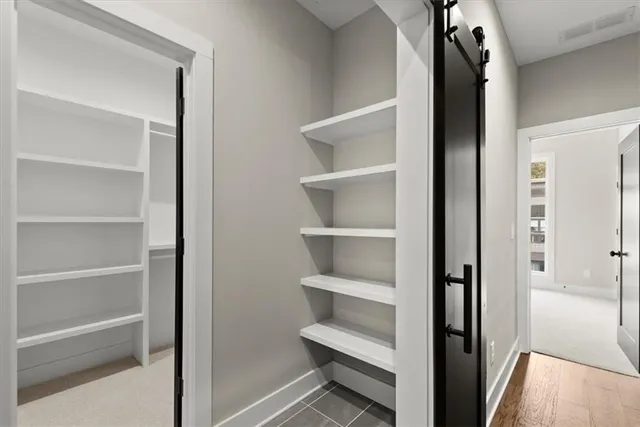 a view of staircase with white walls and a window