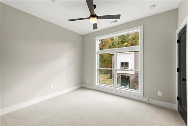 a view of a livingroom with wooden floor and staircase