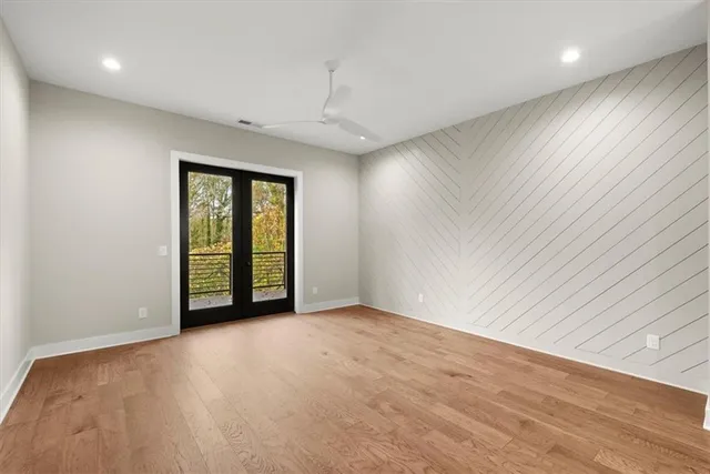 a view of a balcony with wooden floor and fence