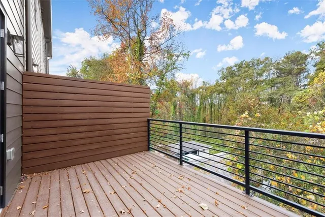 a view of a balcony with wooden floor and fence