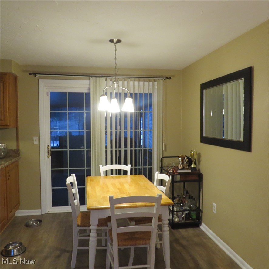 46580 Middle Ridge Road Amherst, OH 44001 - Photo 38 of 38 Dining space featuring dark wood-style floors and a chandelier