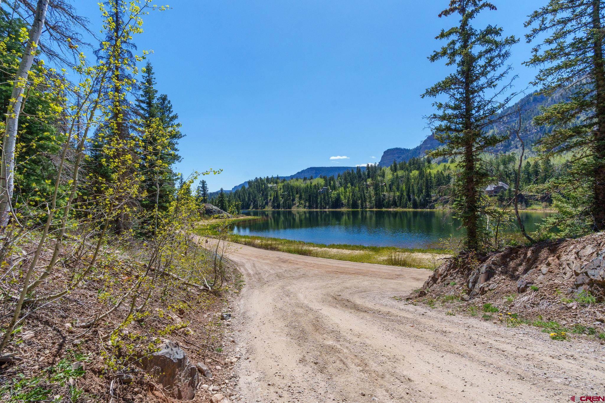 361 Deer Run Way Durango, CO 81301 - Photo 9 of 29 a view of a lake with a house in the background