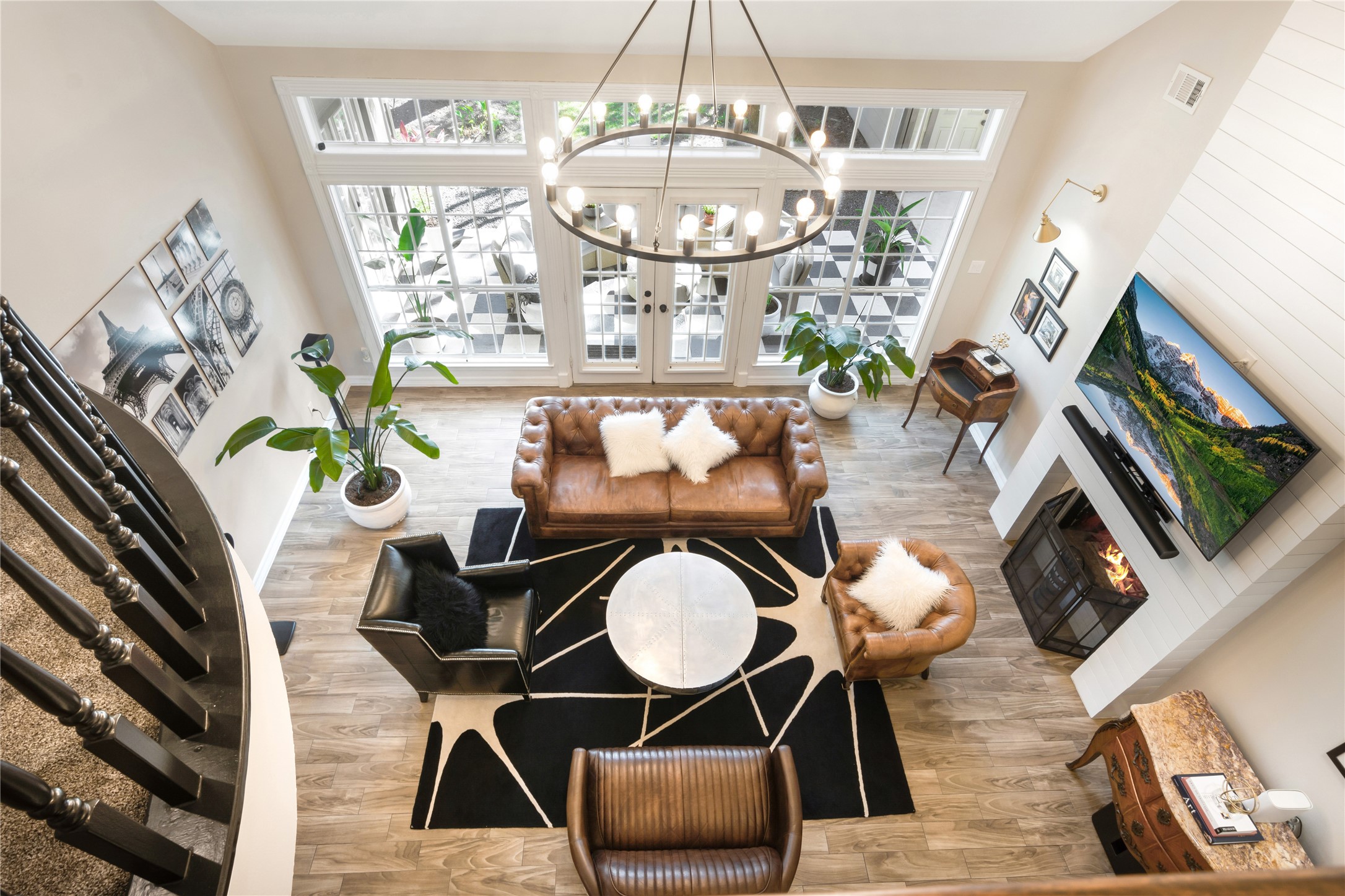 a dining room with furniture a chandelier and wooden floor