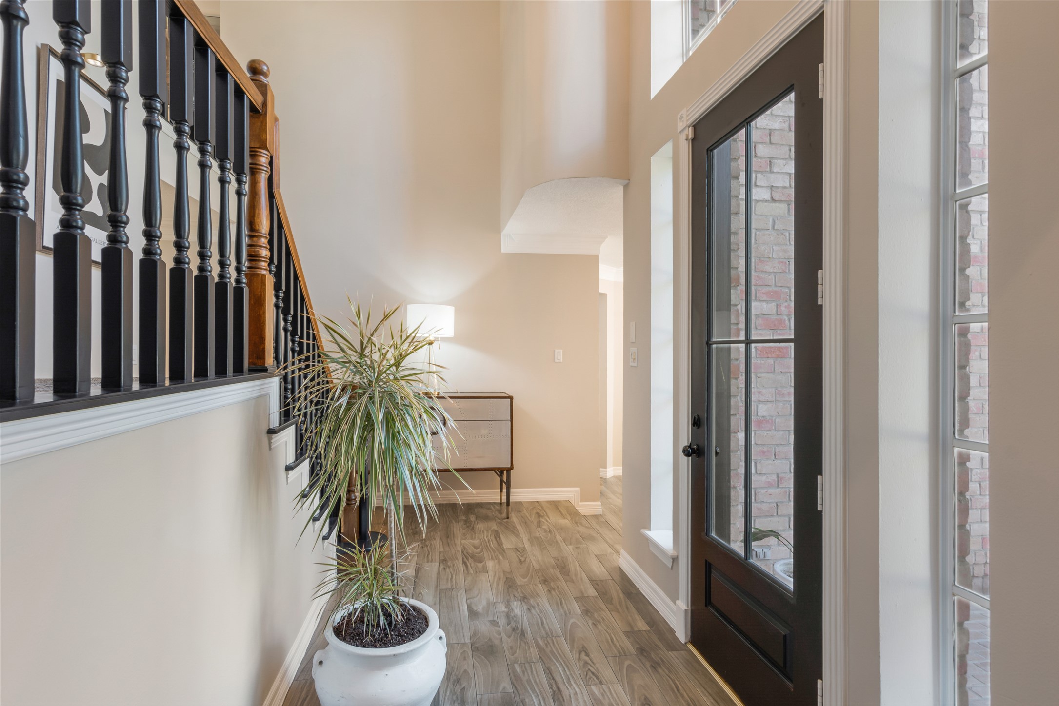 6211 Kingscrest Lane Spring, TX 77389 - Photo 5 of 38 a view of a hallway with wooden floor and a potted plant