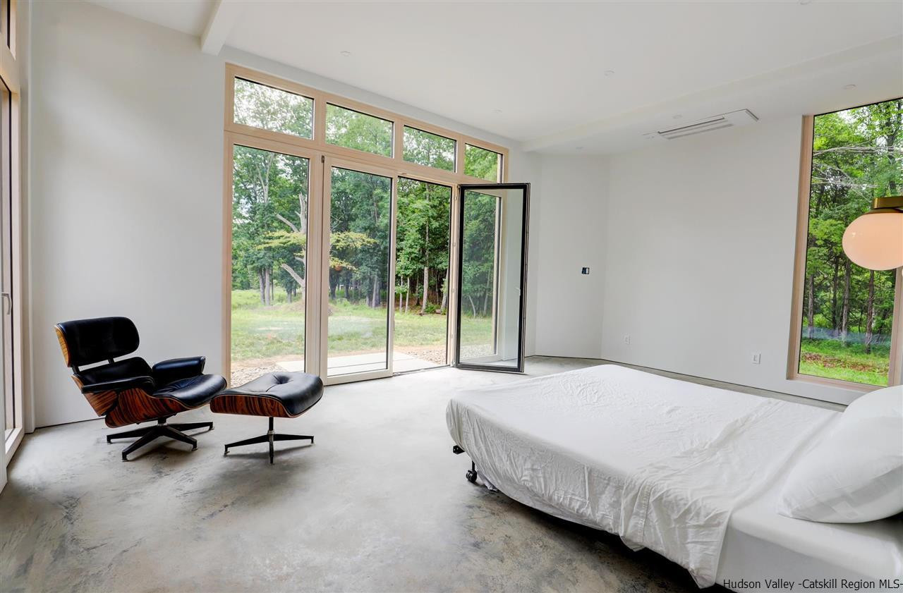 10 Old Runway Road Stone Ridge, NY 12484 - Photo 14 of 32 a bed sitting in a bedroom next to a window