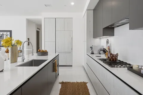 a kitchen with a sink stove and cabinets