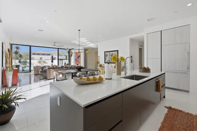 a kitchen with sink and view living room