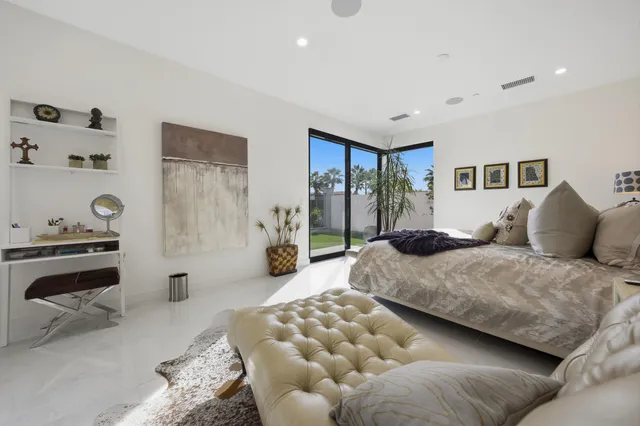 a bedroom with a large bed and a couch