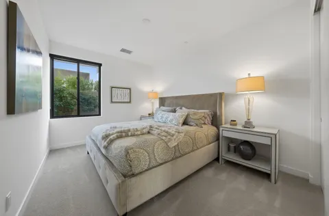 a bedroom with a bed and a lamp