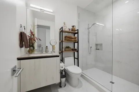 a bathroom with a toilet and a shower
