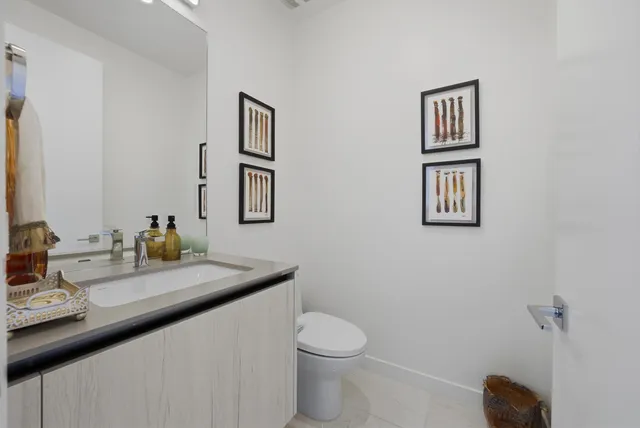 a bathroom with a toilet sink and mirror