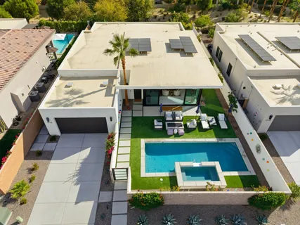 a view of a house with pool and chairs