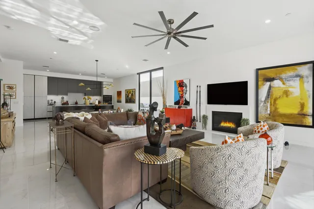 a living room with fireplace furniture and a flat screen tv