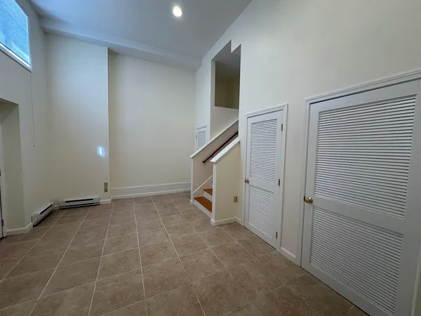 a view of an empty room with stairs