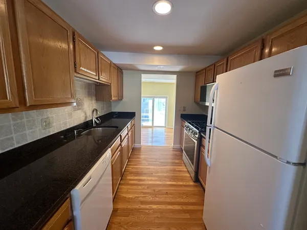 a kitchen with a refrigerator and a sink