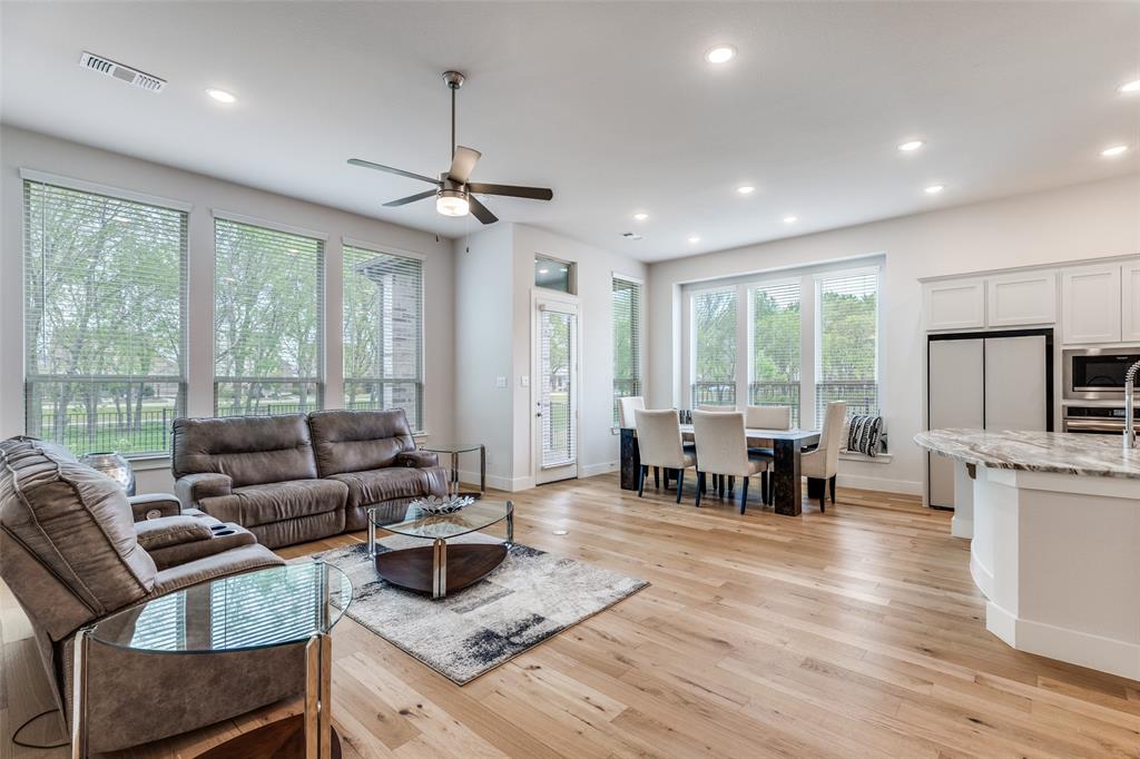 1835 Bell Court Van Alstyne, TX 75495 - Photo 2 of 39 Open concept living area with extensive engineered wood flooring and peaceful greenbelt views