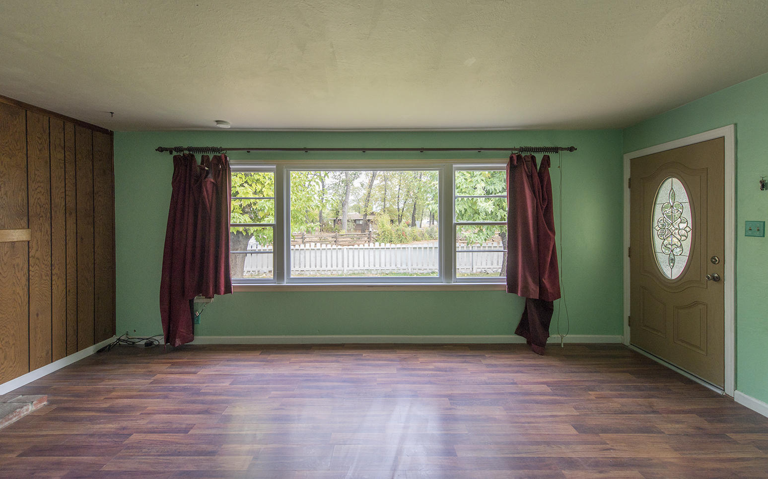 3062 Lawrence Road Redding, CA 96002 - Photo 3 of 16 wooden floor in an empty room with a window