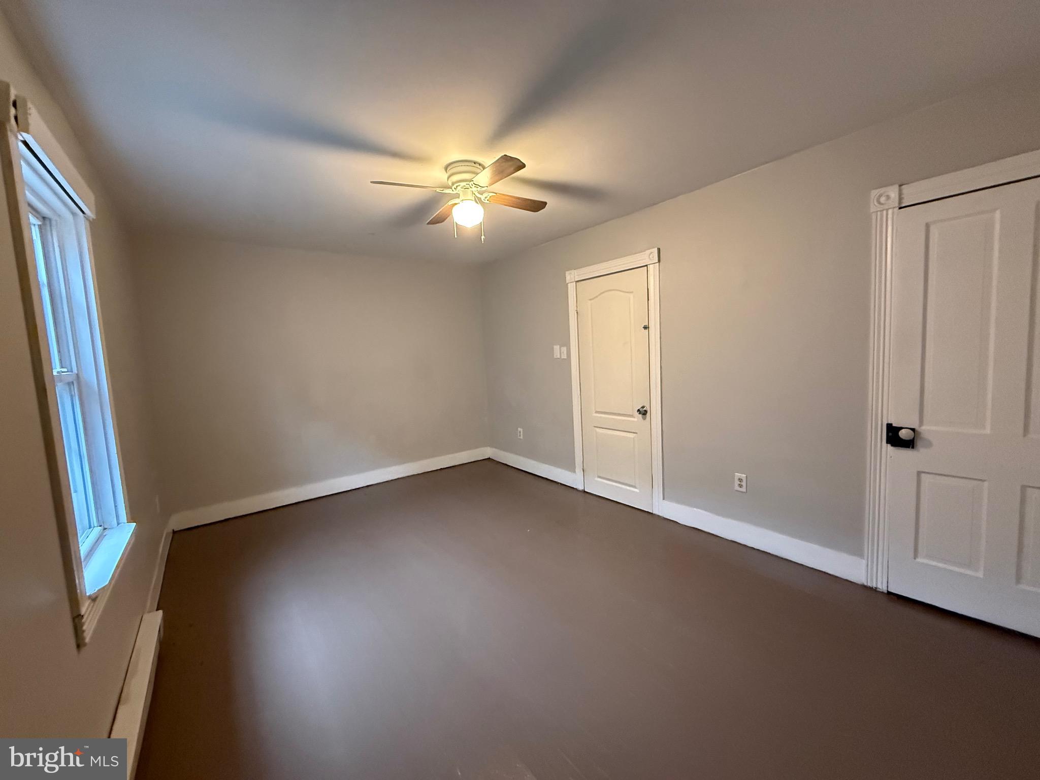 8 South Maple Avenue Brunswick, MD 21716 - Photo 3 of 13 an empty room with windows and fan