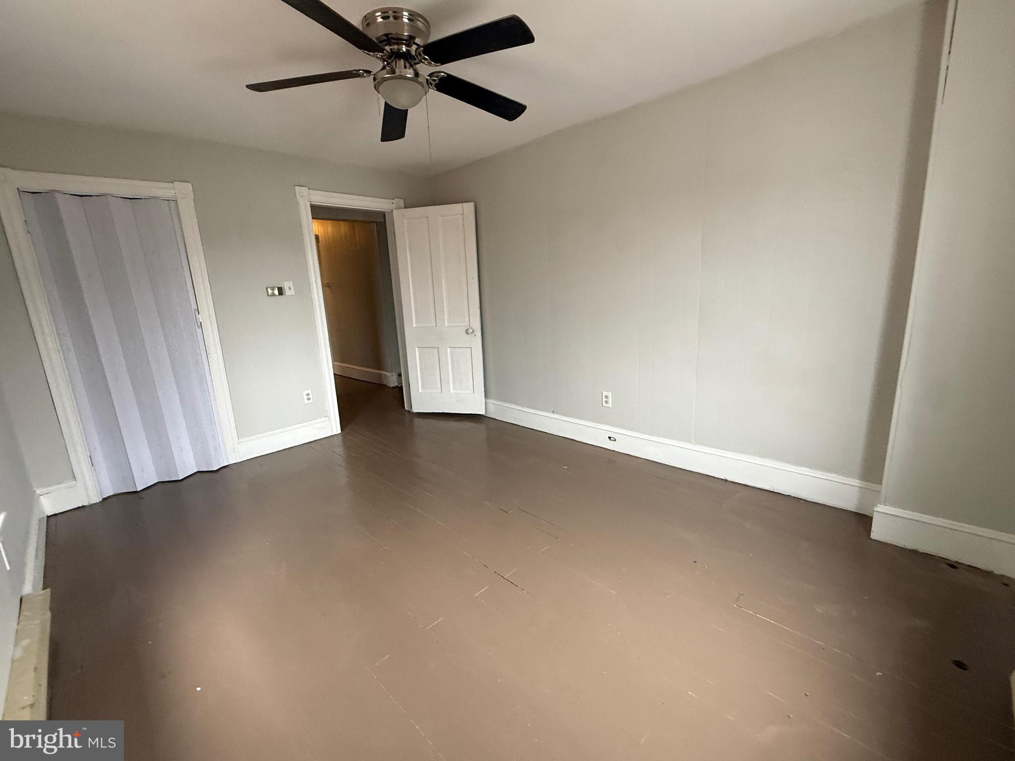 8 South Maple Avenue Brunswick, MD 21716 - Photo 4 of 13 an empty room with a ceiling fan and window