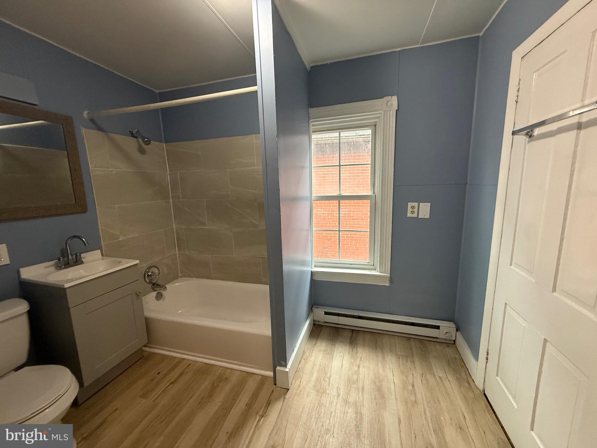 8 South Maple Avenue Brunswick, MD 21716 - Photo 6 of 13 a bathroom with a sink toilet and shower