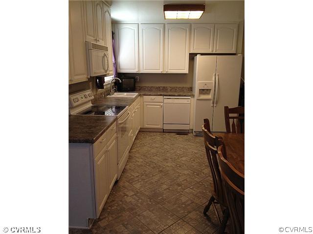 3218 Brookforest Road Midlothian, VA 23112 - Photo 8 of 12 a kitchen with a sink refrigerator and cabinets