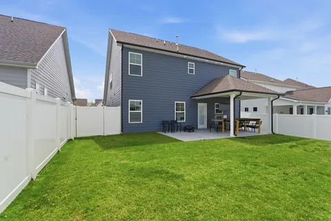 a view of a house with a yard and sitting area