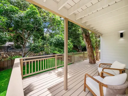 a balcony with wooden floor and furniture