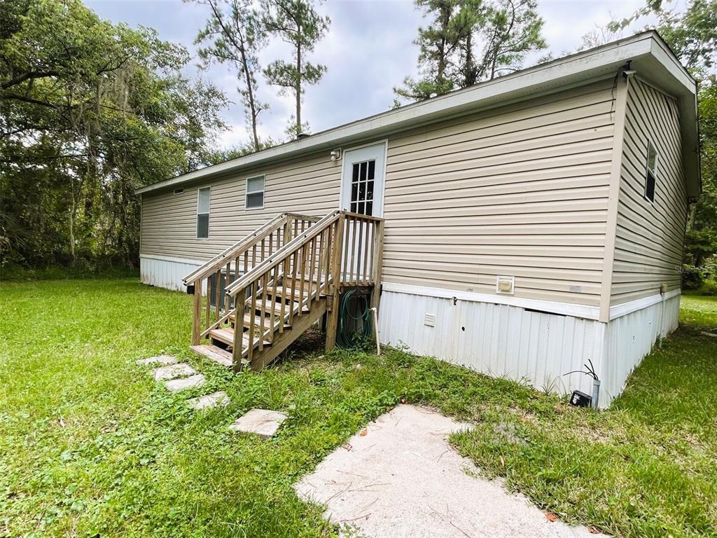328 Old Peniel Road Palatka, FL 32177 - Photo 16 of 18 a view of a house with a yard