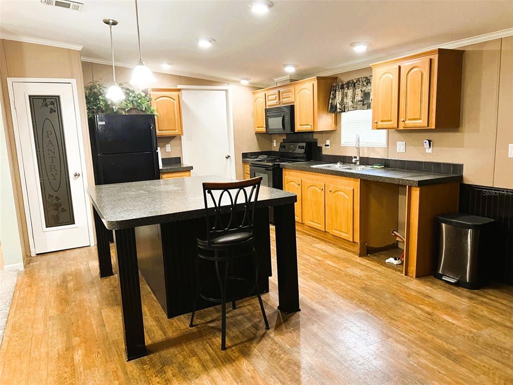 328 Old Peniel Road Palatka, FL 32177 - Photo 2 of 18 a kitchen with granite countertop wooden floors cabinets a sink and appliances