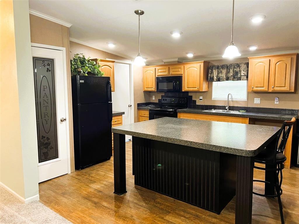 328 Old Peniel Road Palatka, FL 32177 - Photo 4 of 18 a kitchen with stainless steel appliances granite countertop a sink a stove and a refrigerator