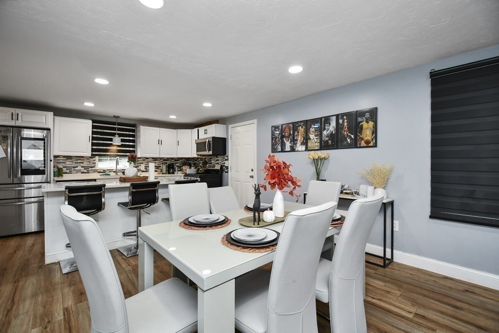 44 Catalpa Circle Worcester, MA 01603 - Photo 11 of 29 a kitchen with a dining table chairs and refrigerator