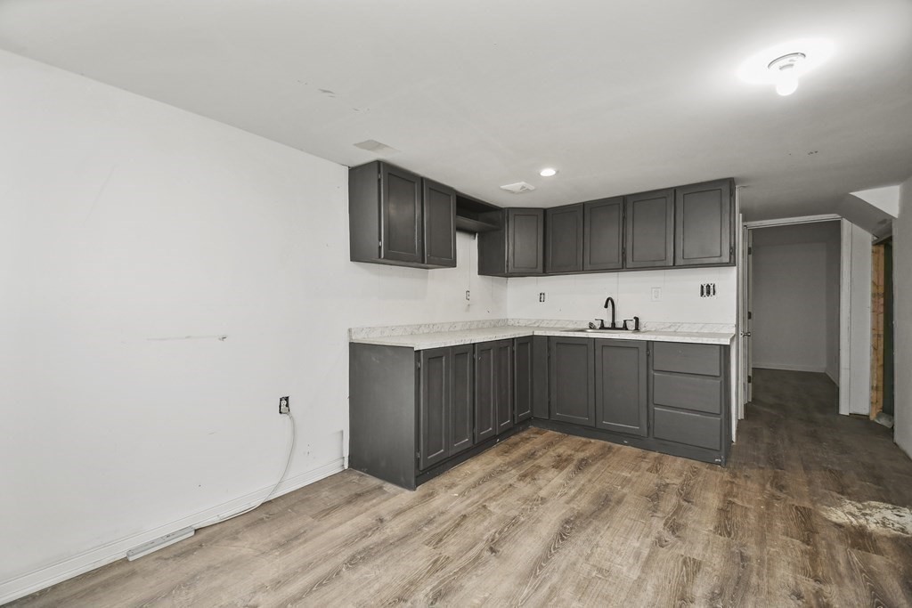 44 Catalpa Circle Worcester, MA 01603 - Photo 22 of 29 a kitchen with a sink cabinets and wooden floor