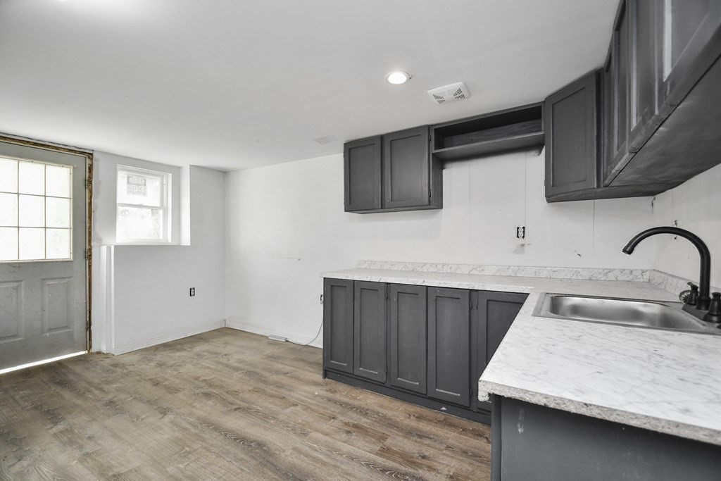 44 Catalpa Circle Worcester, MA 01603 - Photo 23 of 29 a kitchen with sink cabinets and outdoor space