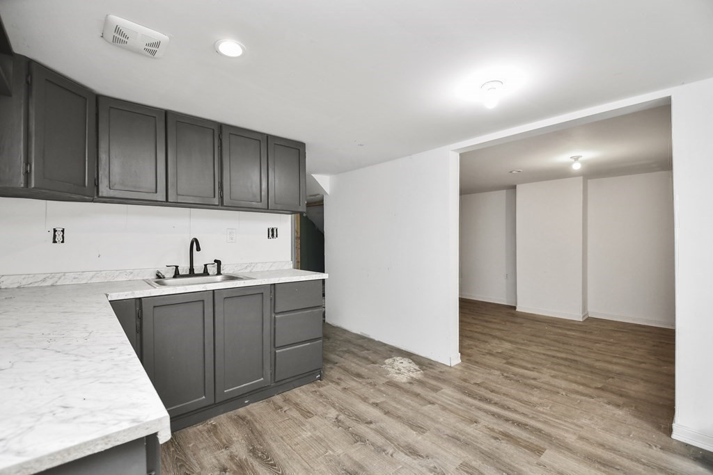 44 Catalpa Circle Worcester, MA 01603 - Photo 24 of 29 a kitchen with granite countertop wooden cabinets and sink