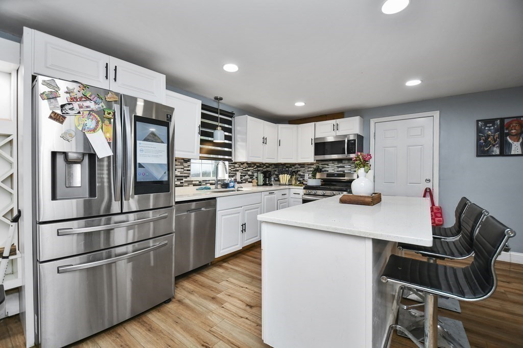 44 Catalpa Circle Worcester, MA 01603 - Photo 7 of 29 a kitchen with stainless steel appliances kitchen island granite countertop a refrigerator stove top oven and sink