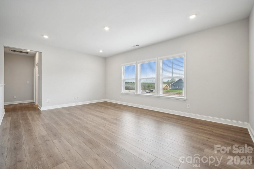 5029 Duval Circle Tega Cay, SC 29708 - Photo 22 of 47 an empty room with wooden floor and windows