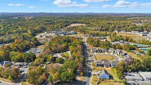an aerial view of a swimming pool with outdoor seating