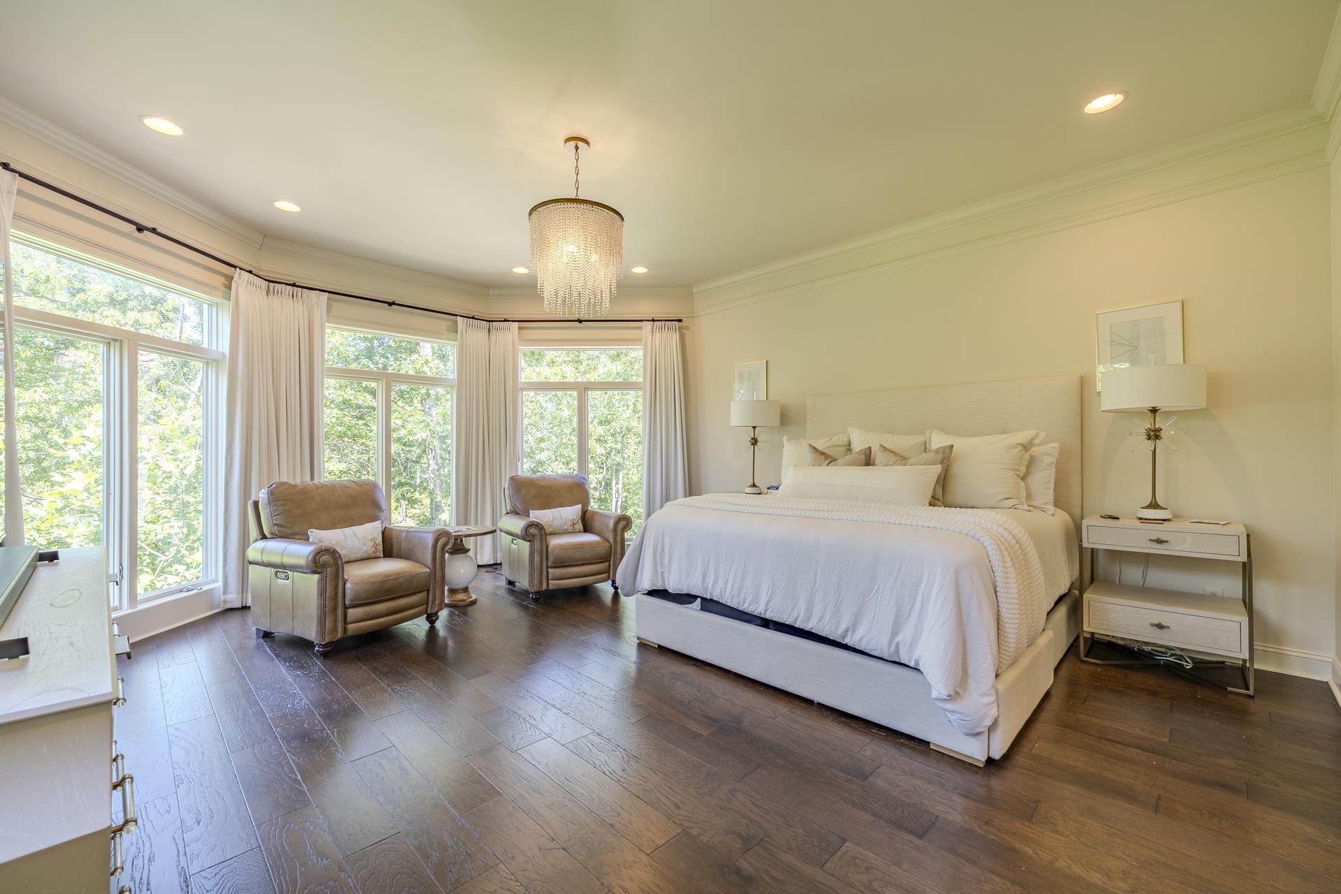 105 Riviera Cove Savannah, TN 38372 - Photo 15 of 40 a spacious bedroom with a bed and wooden floor