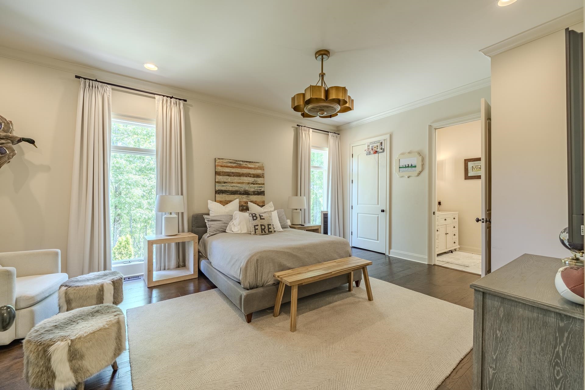 105 Riviera Cove Savannah, TN 38372 - Photo 22 of 40 a bedroom with a bed and a chandelier