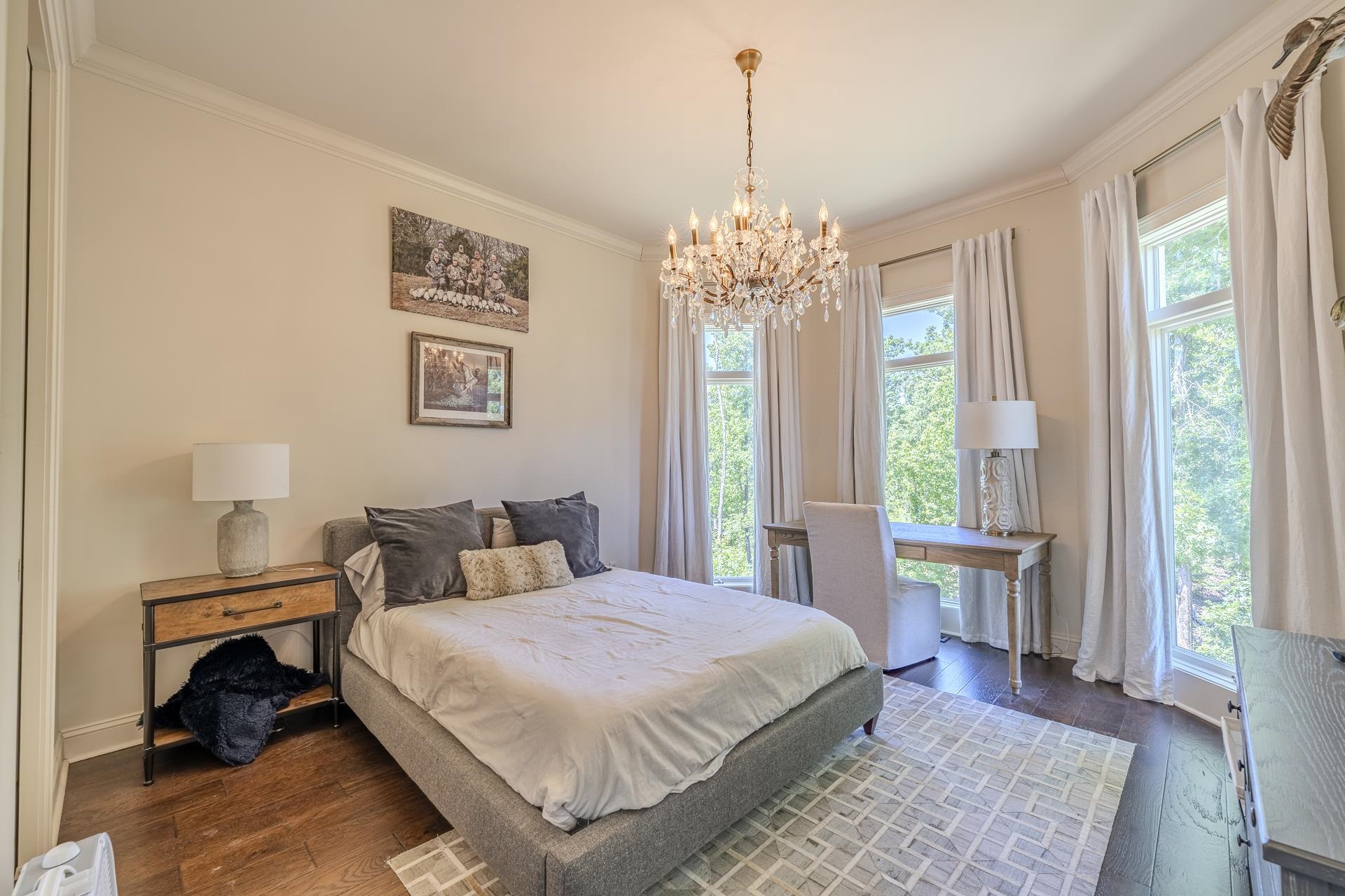 105 Riviera Cove Savannah, TN 38372 - Photo 28 of 40 a spacious bedroom with a bed and a table in it with window