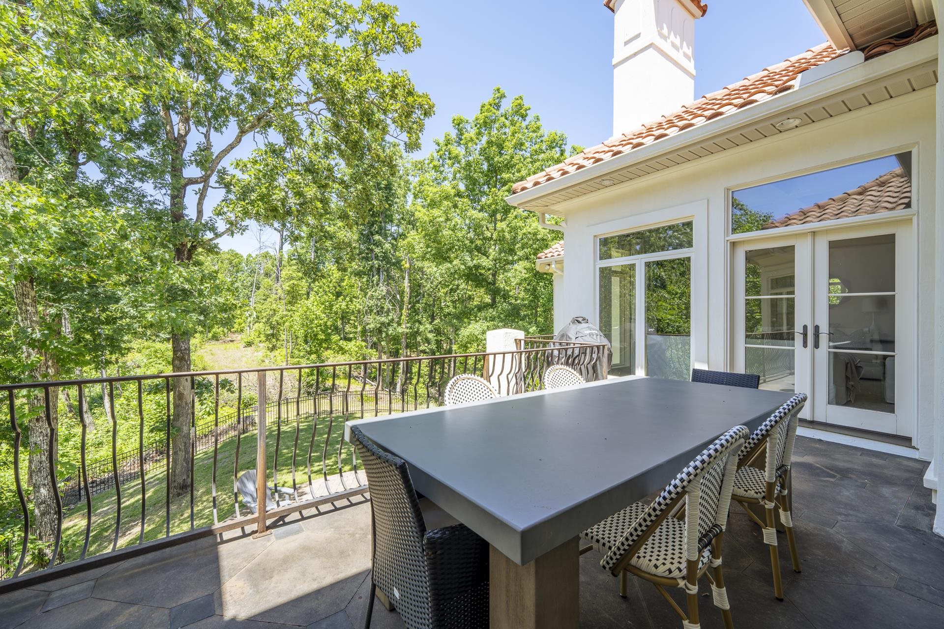 105 Riviera Cove Savannah, TN 38372 - Photo 32 of 40 a view of a balcony with table and chairs and floor to ceiling window with wooden fence