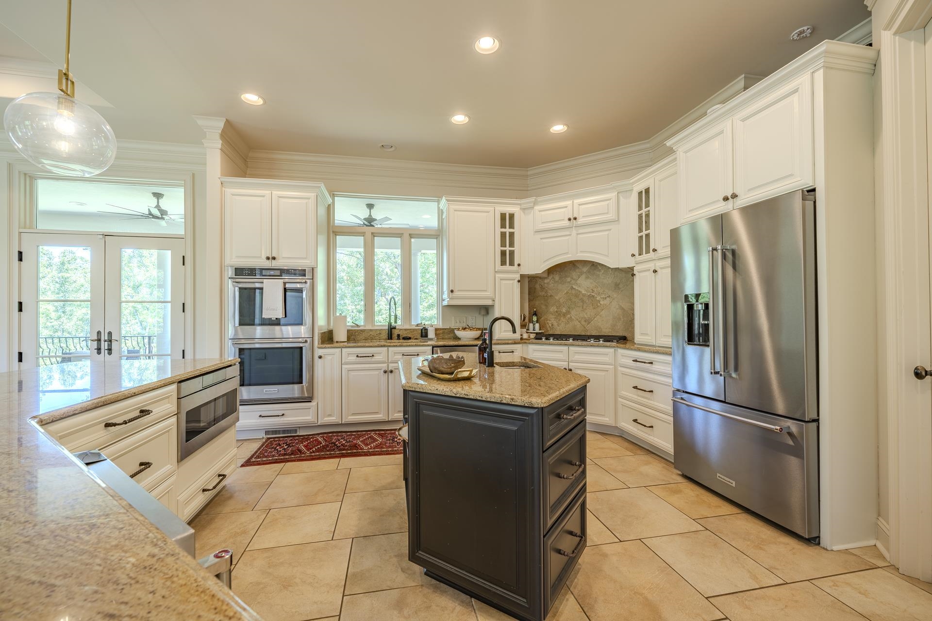 105 Riviera Cove Savannah, TN 38372 - Photo 10 of 40 a kitchen with stainless steel appliances granite countertop a refrigerator oven stove a sink a dining table and chairs