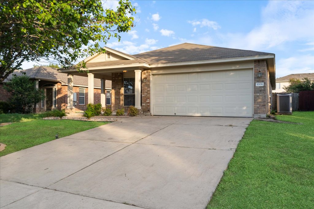 1006 Gentry Drive Leander, TX 78641 - Photo 1 of 1 front view of house with a yard
