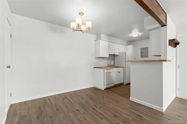 a view of a kitchen with wooden floor and a sink