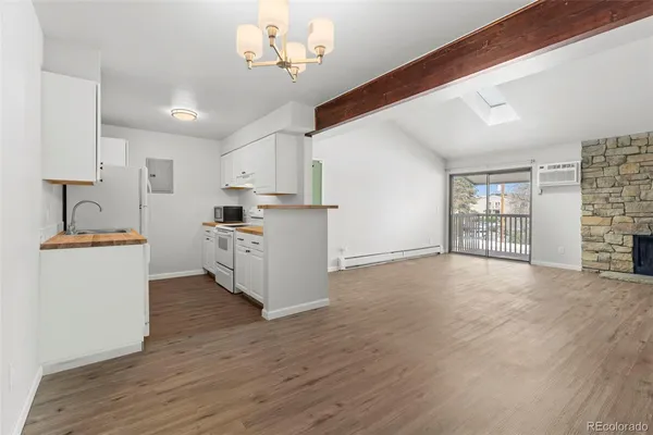 a view of a kitchen with cabinets and wooden floor