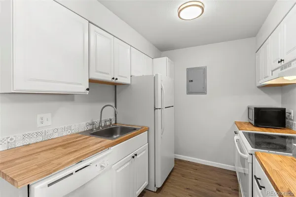 a kitchen with stainless steel appliances granite countertop a sink stove and microwave