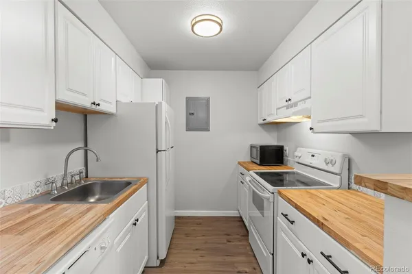 a kitchen with stainless steel appliances granite countertop a sink and cabinets