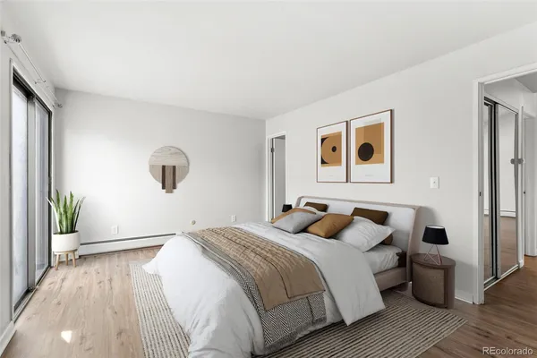 a bedroom with a large bed and a potted plant