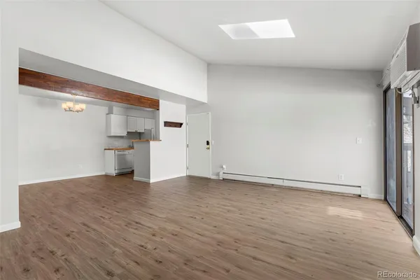 a view of empty room with wooden floor