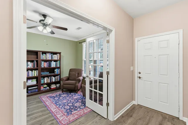 a living room with furniture a flat screen tv and a large window